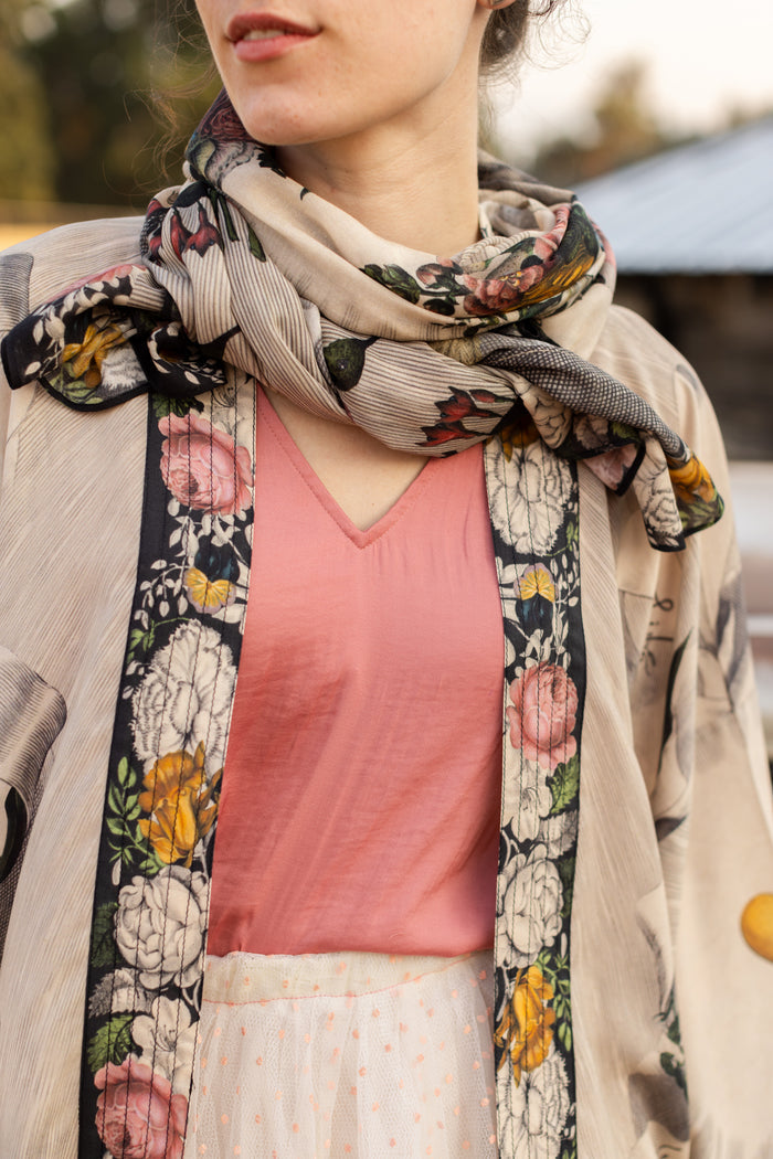 Model wearing Take My Hand scarf with 1600s hand engraving of clasped hands, a painted heart, florals and sun rays – Market of Stars