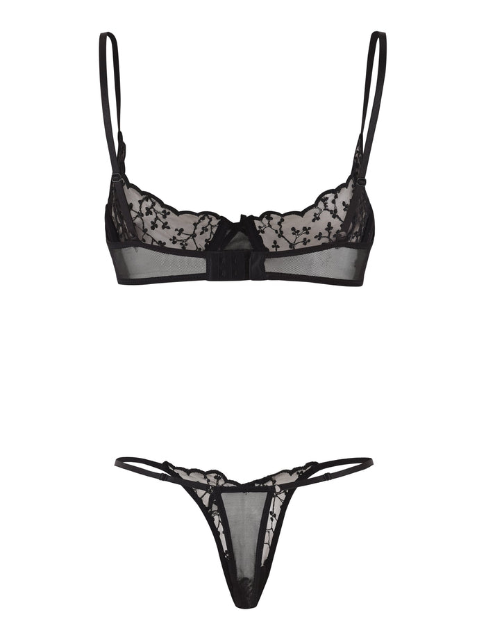 Introducing the TALIYAH SET - BLACK by TIGERMIST: This exquisite lingerie set features a lace bra with adjustable straps and an underwire cup, adorned with intricate floral lace detailing and a charming central small bow. It is paired with a matching lace thong that boasts similar floral lace accents and delicate thin side straps.