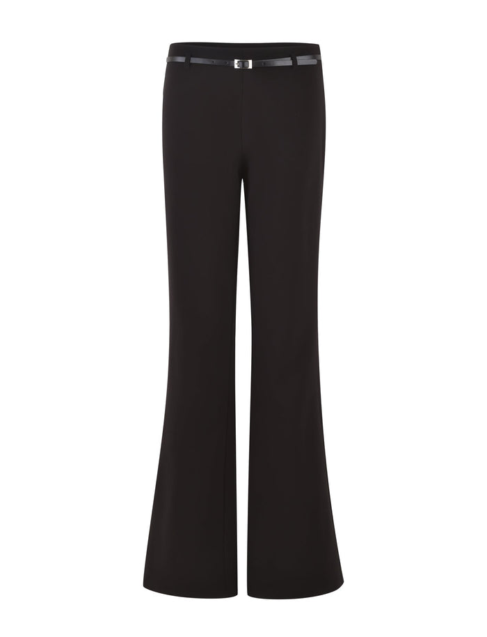 Introducing the TERLA PANT - BLACK by TIGERMIST. This pair of suiting pants features a mid-rise waist and a sleek design. Crafted from smooth fabric, they showcase a tailored finish with a small metallic buckle adding subtle detail to the waistband. The legs widen slightly from the knee downwards, creating an elegant flared silhouette.