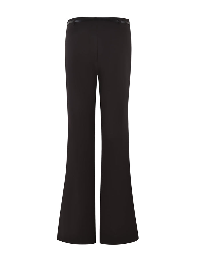 Image shows the TERLA PANT - BLACK by TIGERMIST, featuring a high-waisted, flared silhouette. These sleek suiting pants have a clean design with a slightly wider leg at the bottom, giving them a classic, retro look perfect for fashionable or professional wear.