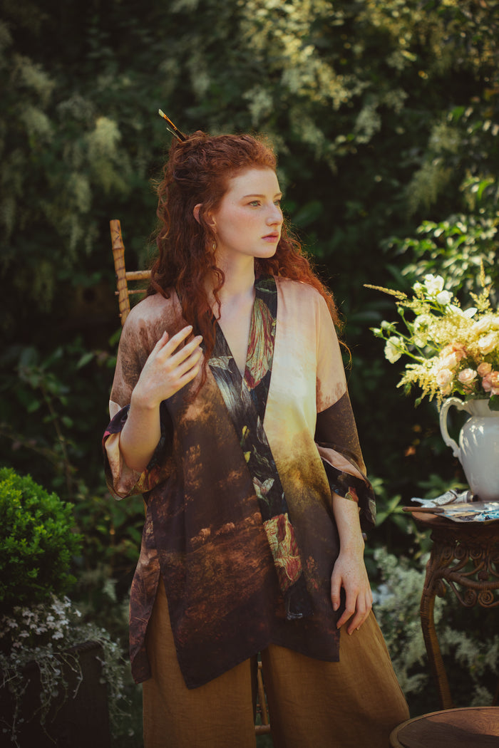 Model wearing The Artist kimono-style duster featuring antique paintings, botanical floral trim, and a radiant golden sun – Market of Stars