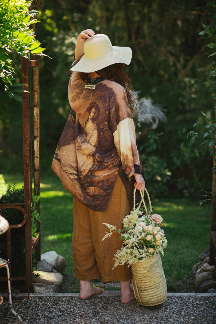 Model wearing The Artist kimono-style duster featuring antique paintings, botanical floral trim, and a radiant golden sun – Market of Stars