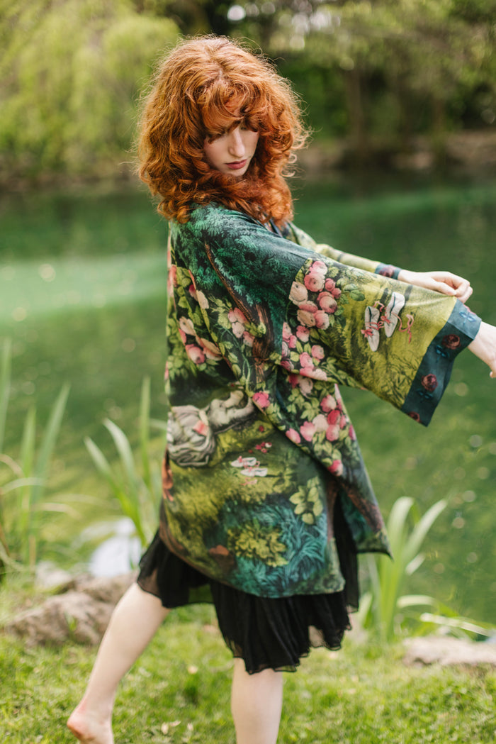 Model wearing a mid-length duster robe ft. hand-coloured etching from the 1880s called The Bower of Roses - Market of Stars