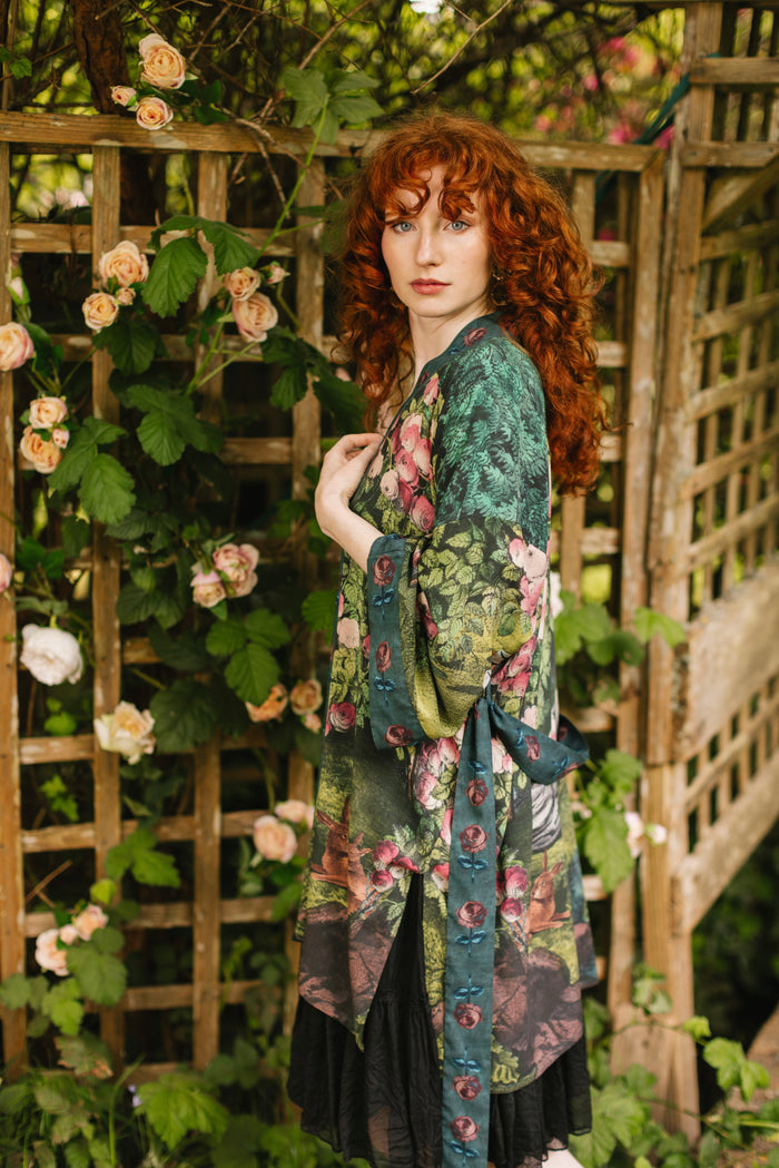 Model wearing a mid-length duster robe ft. hand-coloured etching from the 1880s called The Bower of Roses - Market of Stars