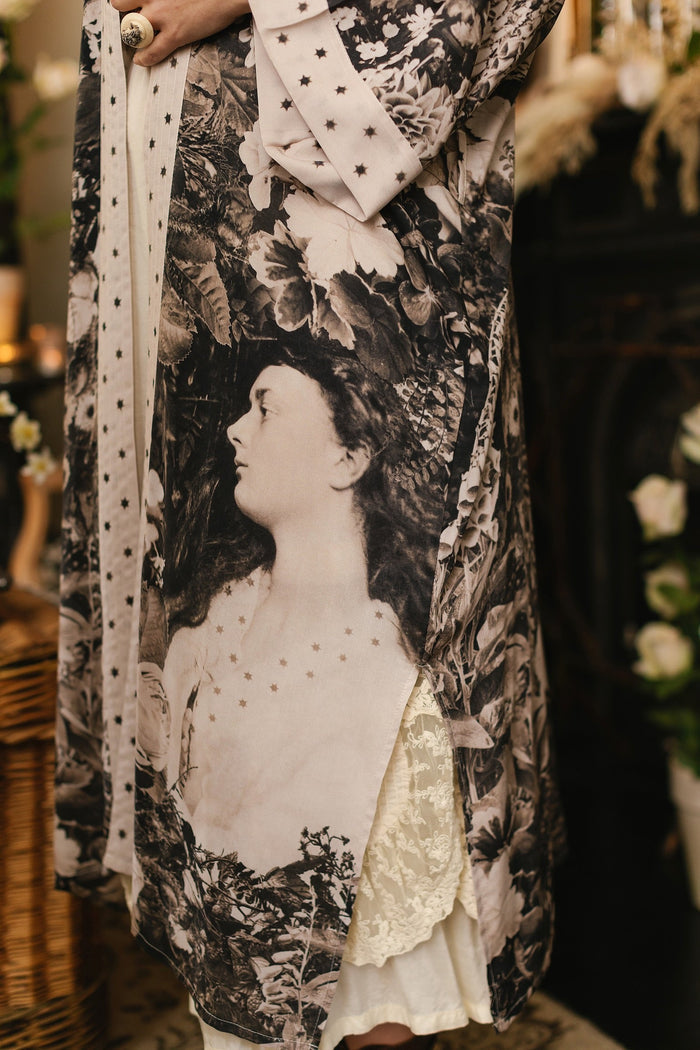 Model wearing Looking Glass Opera Robe featuring grown-up Alice Liddell, Victorian botanicals, and celestial star and moon accents inspired by Wonderland – Market of Stars.