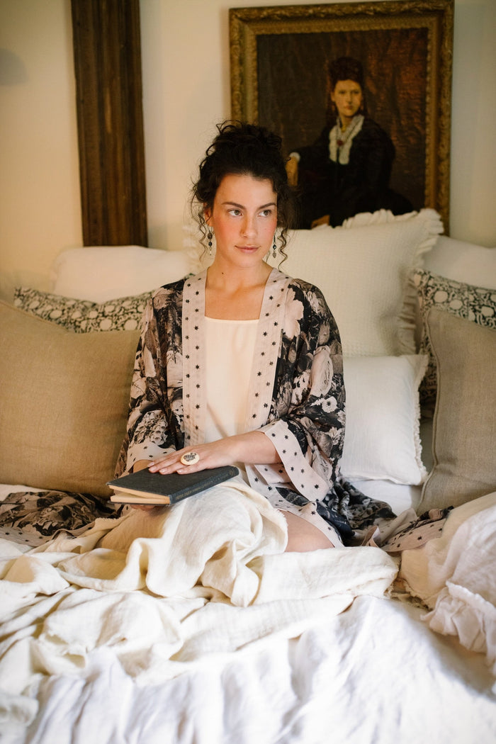 Model wearing Looking Glass Opera Robe featuring grown-up Alice Liddell, Victorian botanicals, and celestial star and moon accents inspired by Wonderland – Market of Stars.