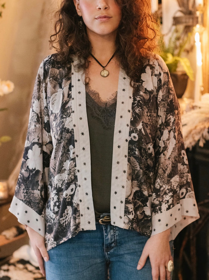 Model wearing Looking Glass Cropped Kimono featuring grown-up Alice Liddell, rare Victorian botanicals, and celestial star and moon accents inspired by Wonderland – Market of Stars.