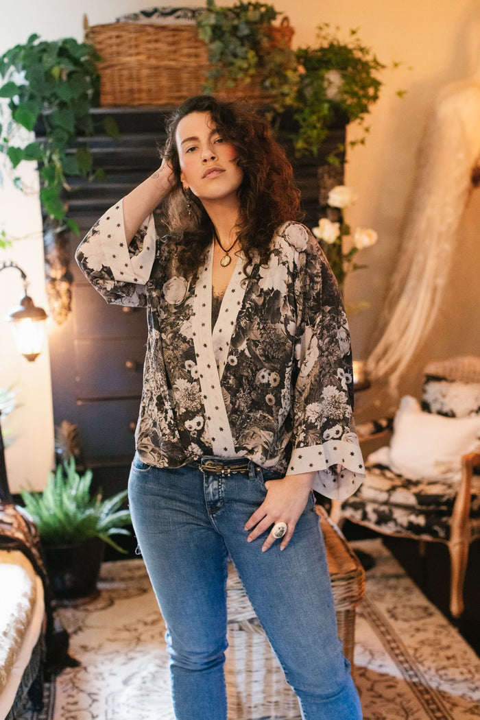 Model wearing Looking Glass Cropped Kimono featuring grown-up Alice Liddell, rare Victorian botanicals, and celestial star and moon accents inspired by Wonderland – Market of Stars.