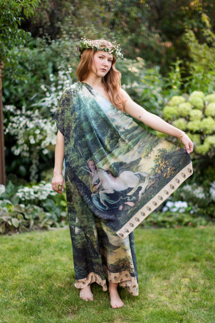 Model wearing a bamboo-viscose scarf ft. vintage artwork & unicorn lorn set against a mossy-green landscape — a romantic piece for the modern dreamer - Market of Stars