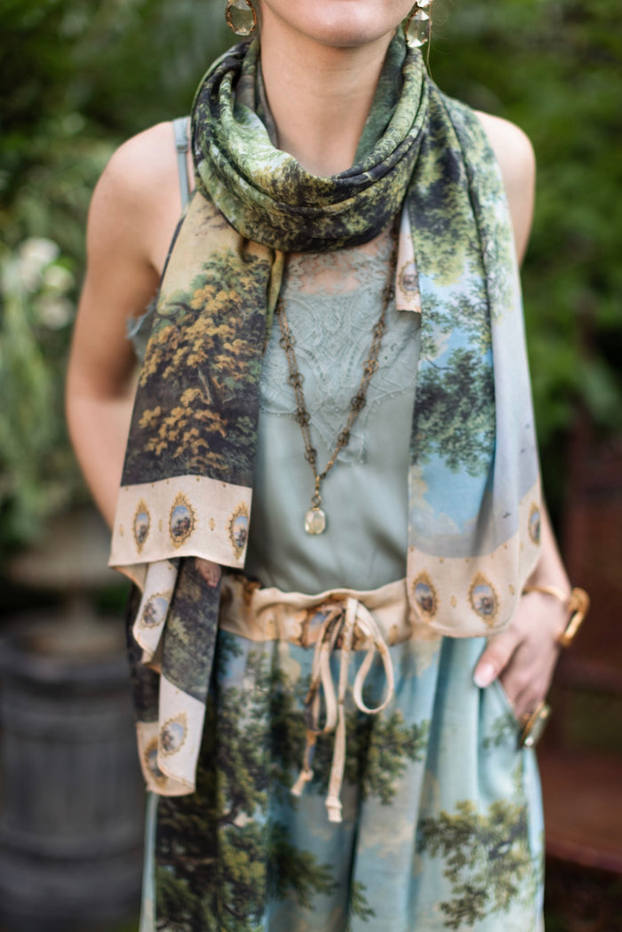 Model wearing a bamboo-viscose scarf ft. vintage artwork & unicorn lorn set against a mossy-green landscape — a romantic piece for the modern dreamer - Market of Stars