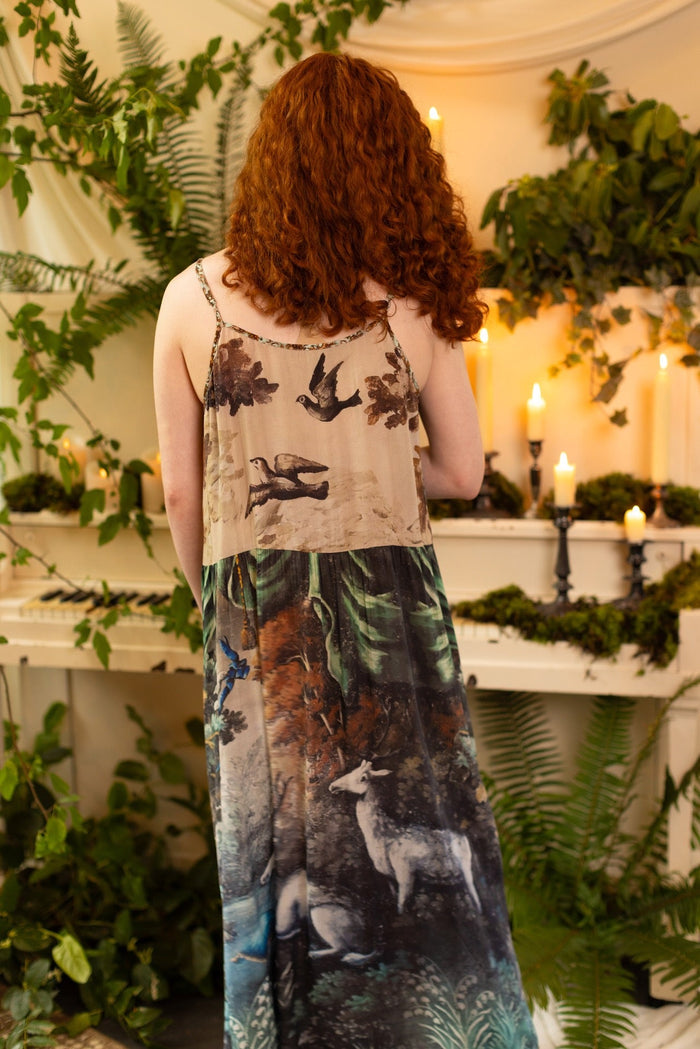Model wearing our Theatre of Dreams Slip Dress featuring whimsical deer and birds from Jennifer Lanne’s romantic paintings – Market of Stars