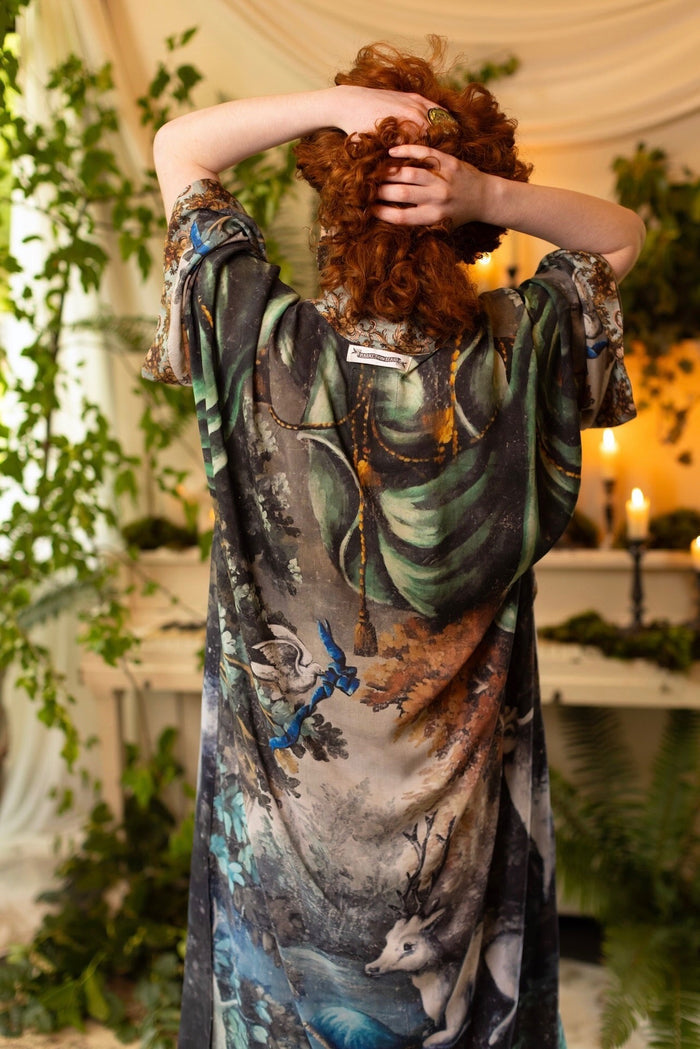 Model wearing the Theatre of Dreams Opera Duster featuring whimsical birds, love letters, and richly painted curtains by artist Jennifer Lanne – Market of Stars