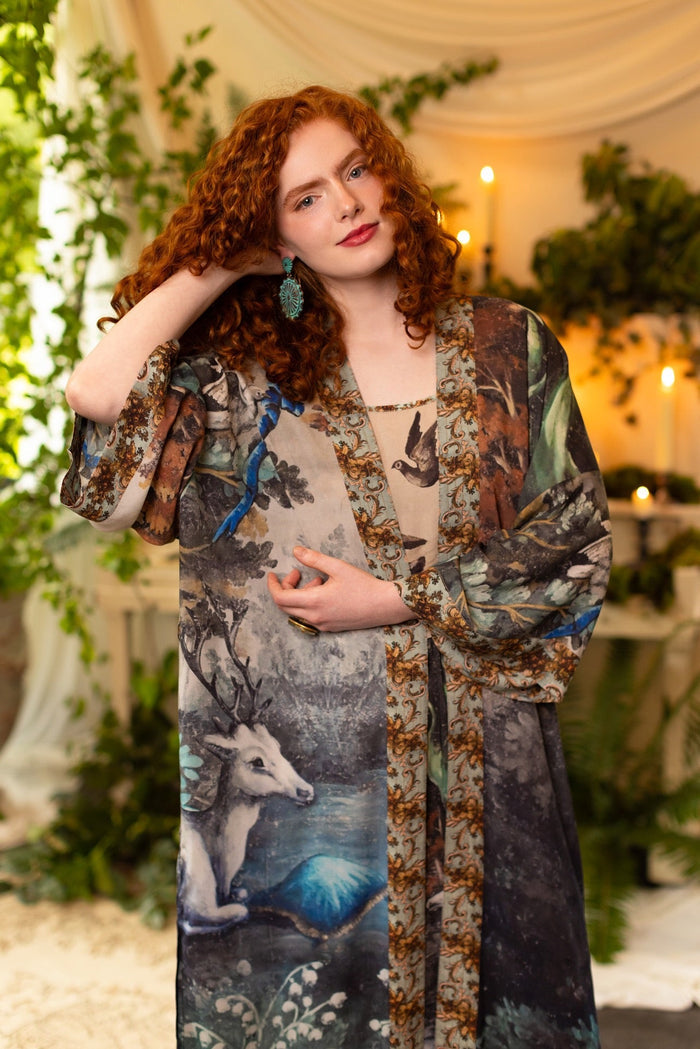 Model wearing the Theatre of Dreams Opera Duster featuring whimsical birds, love letters, and richly painted curtains by artist Jennifer Lanne – Market of Stars