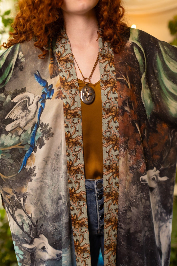 Model wearing the Theatre of Dreams Opera Duster featuring whimsical birds, love letters, and richly painted curtains by artist Jennifer Lanne – Market of Stars