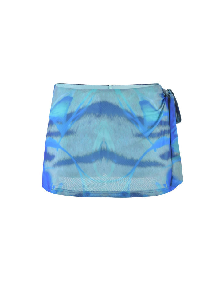 The TINSLEY SKORT - MULTI : ABSTRACT TIE DYE from TIGERMIST is a stylish blue-toned mini skirt featuring a vibrant abstract tie-dye pattern. It boasts a contemporary wrap design with a side tie at the waist, giving it a chic and modern appearance. The fabric looks lightweight and flowy, perfect for any occasion.