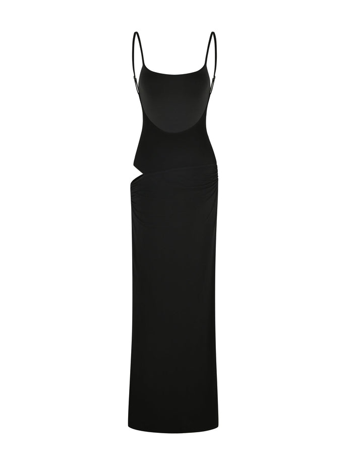 The TIGERMIST UMA DRESS - BLACK is a long, fitted black maxi dress featuring adjustable spaghetti straps and an asymmetrical waist cut-out, shown on a white background.