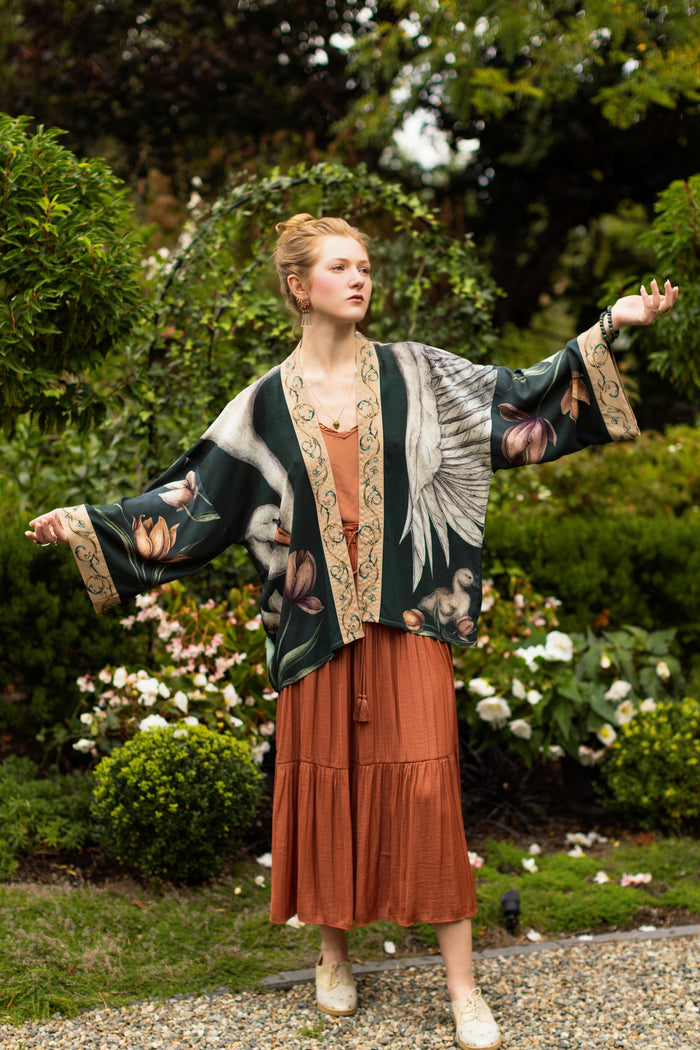 Model wearing a cropped-length duster created in collaboration with artist Jessica Roux and features a trompe l'oeil swan symbolizing protection, love, and grace - Market of Stars.