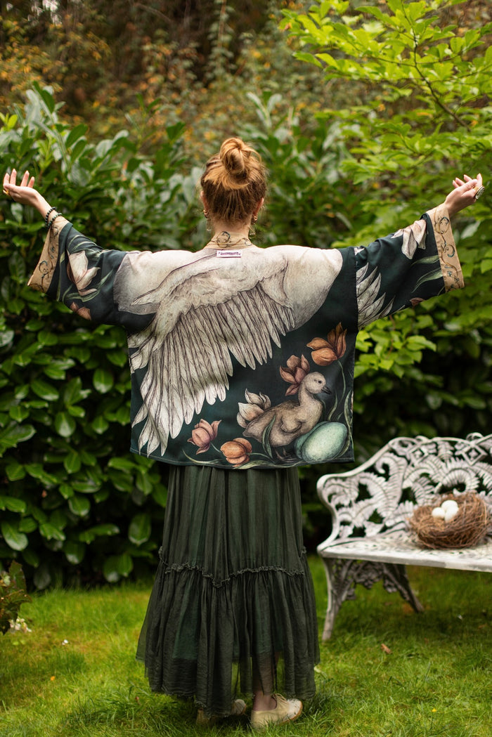 Model wearing a cropped-length duster created in collaboration with artist Jessica Roux and features a trompe l'oeil swan symbolizing protection, love, and grace - Market of Stars.