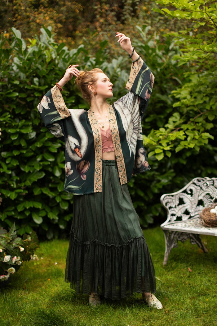Model wearing a cropped-length duster created in collaboration with artist Jessica Roux and features a trompe l'oeil swan symbolizing protection, love, and grace - Market of Stars.