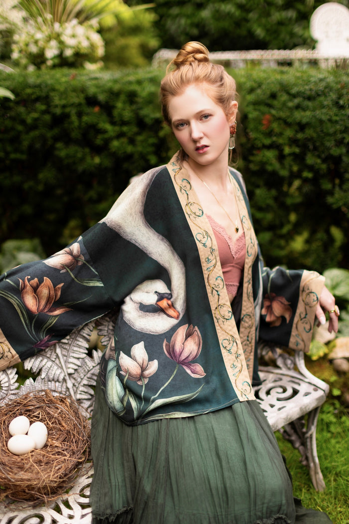 Model wearing a cropped-length duster created in collaboration with artist Jessica Roux and features a trompe l'oeil swan symbolizing protection, love, and grace - Market of Stars.