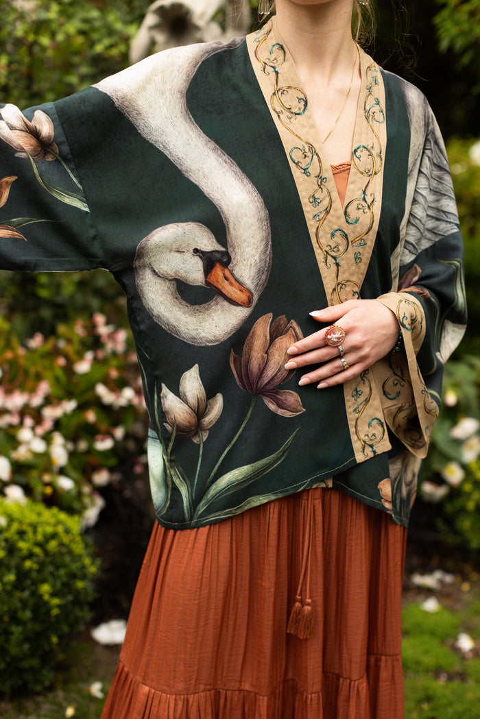Model wearing a cropped-length duster created in collaboration with artist Jessica Roux and features a trompe l'oeil swan symbolizing protection, love, and grace - Market of Stars.