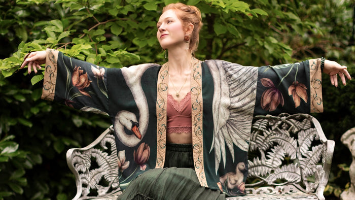 Model wearing a cropped-length duster created in collaboration with artist Jessica Roux and features a trompe l'oeil swan symbolizing protection, love, and grace - Market of Stars.