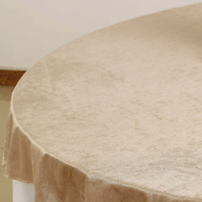 Beige round tablecloth on a table surface.