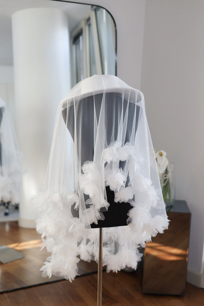 White bridal hat with floral wedding veil.