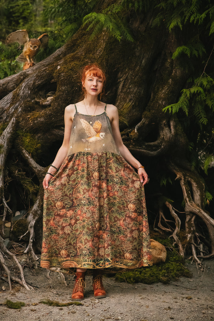Model wearing a bamboo-viscose maxi length slip dress where even the unlikeliest of friends...a fox and a pheasant...find warmth in each other’s company. Created in collaboration with Charles van Sandwyck - Market of Stars