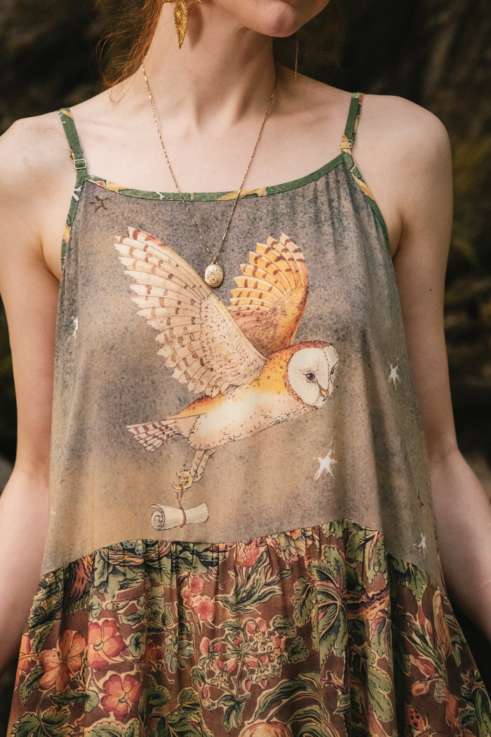 Model wearing a bamboo-viscose maxi length slip dress where even the unlikeliest of friends...a fox and a pheasant...find warmth in each other’s company. Created in collaboration with Charles van Sandwyck - Market of Stars