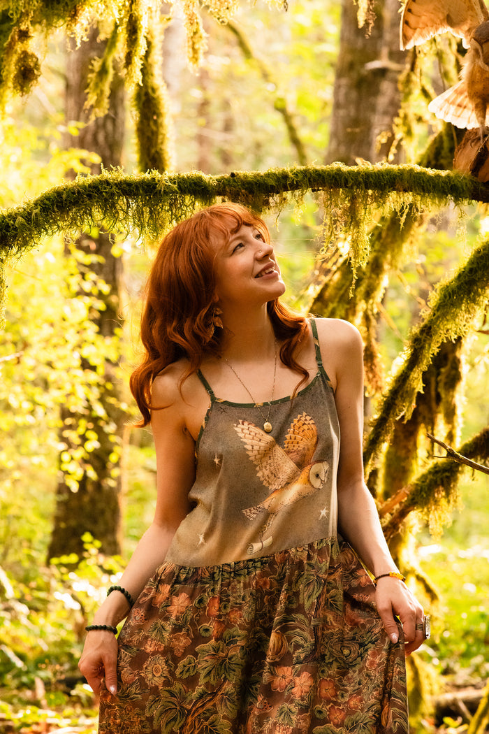 Model wearing a bamboo-viscose maxi length slip dress where even the unlikeliest of friends...a fox and a pheasant...find warmth in each other’s company. Created in collaboration with Charles van Sandwyck - Market of Stars