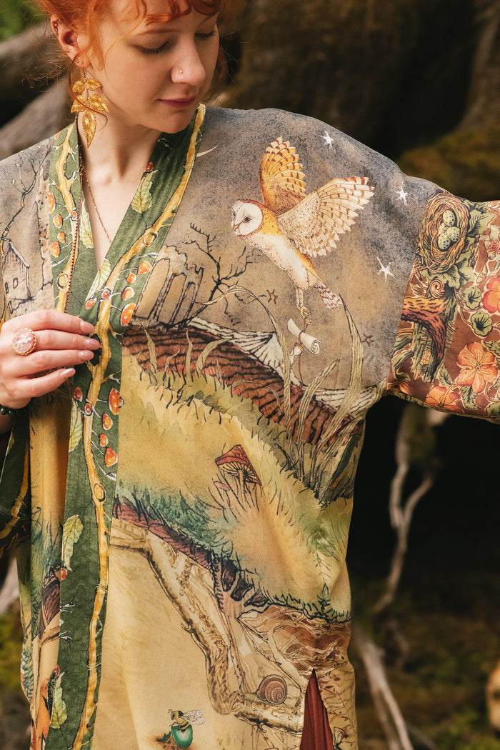 Model wearing a bamboo-viscose mid-length duster kimono robe where even the unlikeliest of friends...a fox and a pheasant...find warmth in each other’s company. Created in collaboration with Charles van Sandwyck - Market of Stars