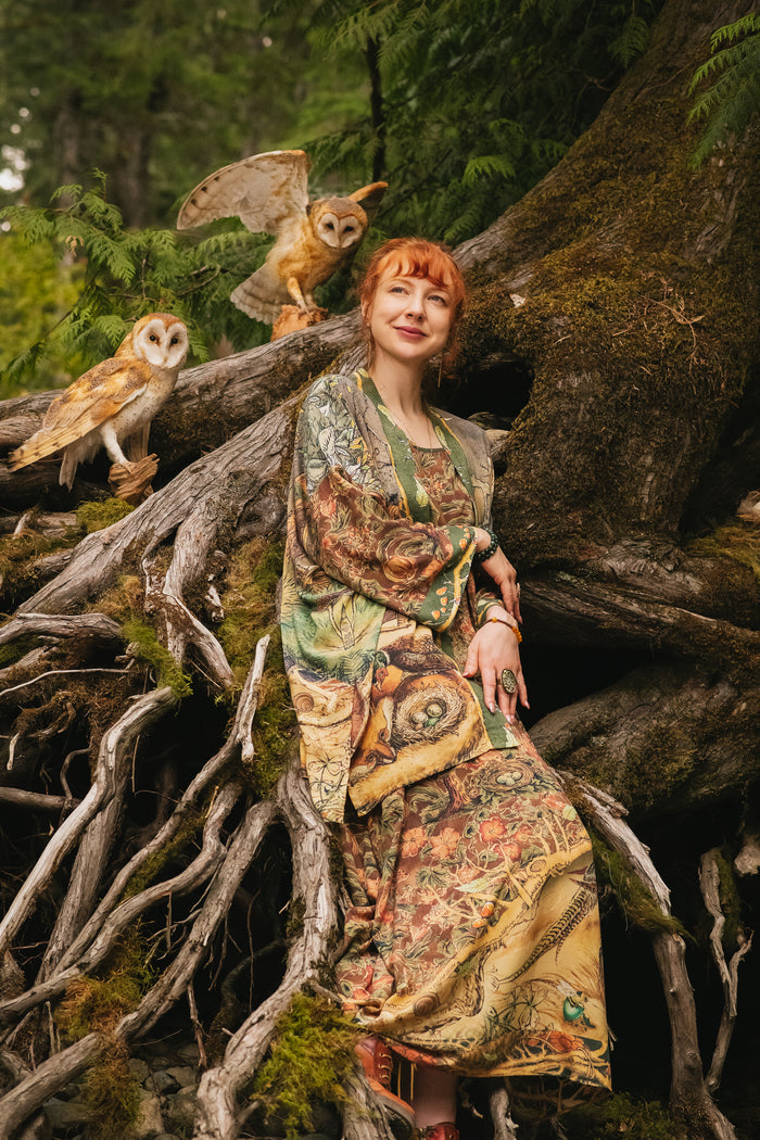 Model wearing a bamboo-viscose mid-length duster kimono robe where even the unlikeliest of friends...a fox and a pheasant...find warmth in each other’s company. Created in collaboration with Charles van Sandwyck - Market of Stars