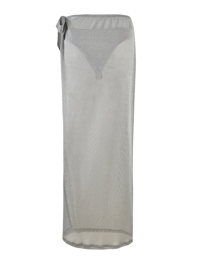 The WYNNE SKIRT - GREY : SILVER by TIGERMIST is a sheer, ankle-length maxi skirt featuring a side tie detail at the low-rise waist. Made from lightweight, see-through material, it's perfect for layering over swimwear.