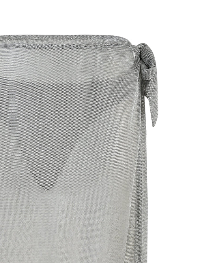A close-up view of the TIGERMIST WYNNE SKIRT - GREY : SILVER, tied in a knot at the top right corner. The slightly see-through fabric unveils a delicate triangular pattern underneath. The texture and weave of the metallic knit are clearly visible, adding an elegant touch to the image.